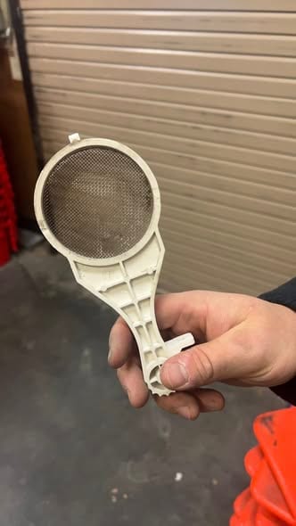 Cleaned tankless intake filter screen after a maintenance service