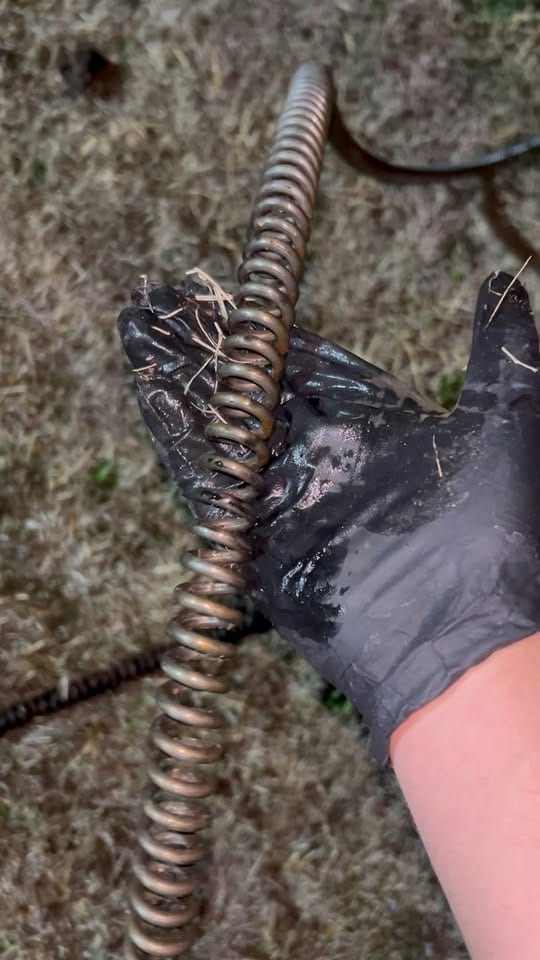 Close-up of debris wound through the sewer cable after pulling it out of the line